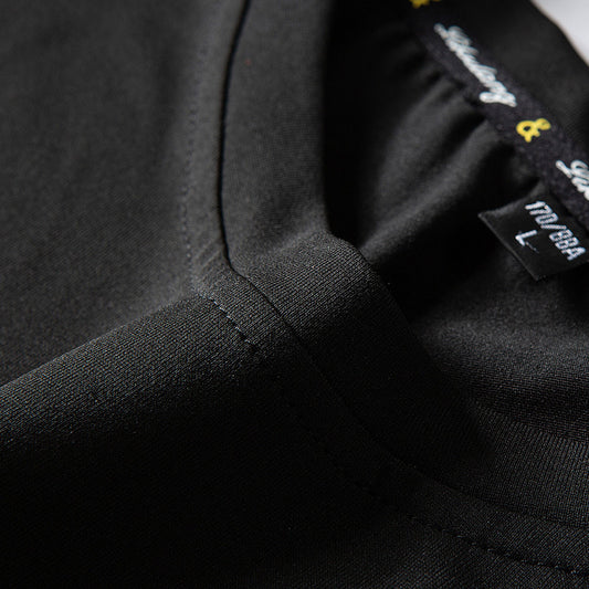 Close-up of a black jacket with a brand label on the chest.