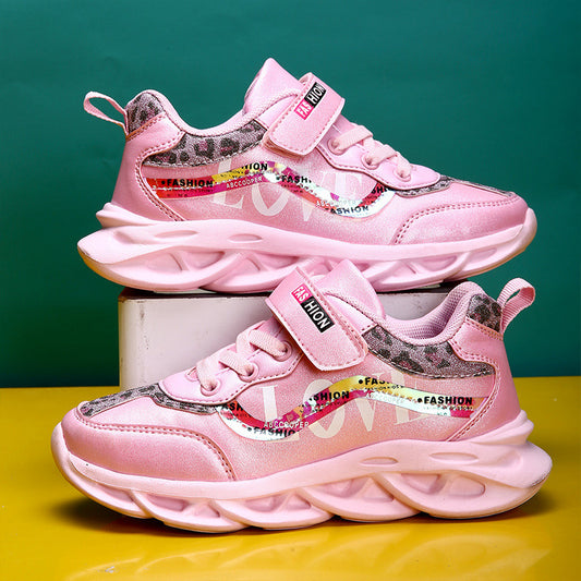 Pink children's sneakers with colorful text on a green and yellow gradient background