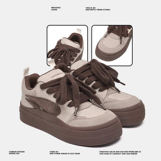Pair of beige and brown sneakers with detailed laces on a light gray background.
