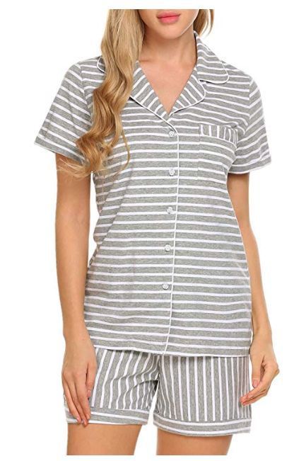 Woman wearing a gray and white striped pajama set on a white background
