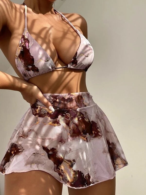 Person wearing a matching bikini set with abstract pattern on a neutral background
