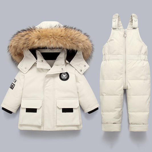 White winter coat with fur hood and snowbib on a light gray background