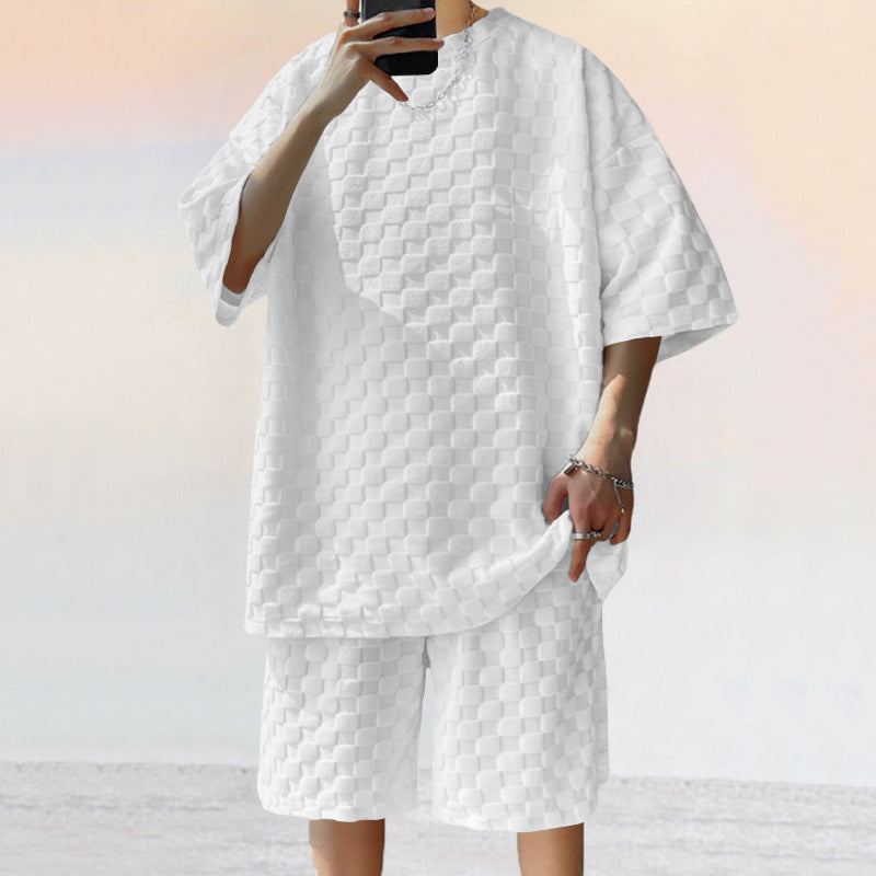 Person wearing a textured white outfit with a plain background