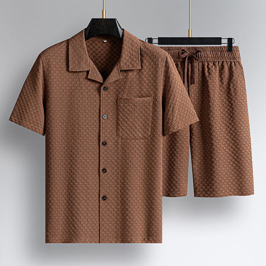 Brown textured shirt and shorts set on hangers against a gray background