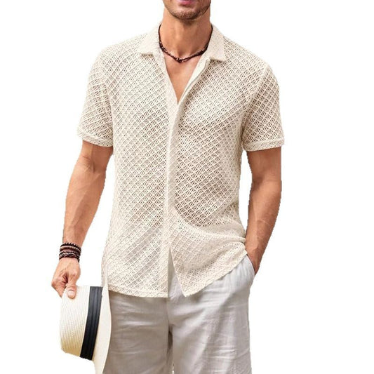 Man wearing a beige patterned shirt and white pants on a white background