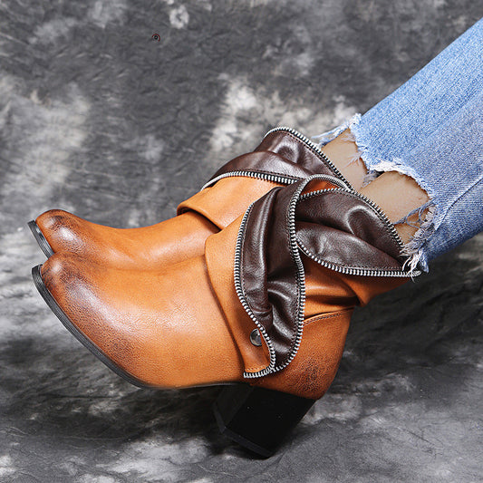 Brown leather boot with a zipper on a gray background