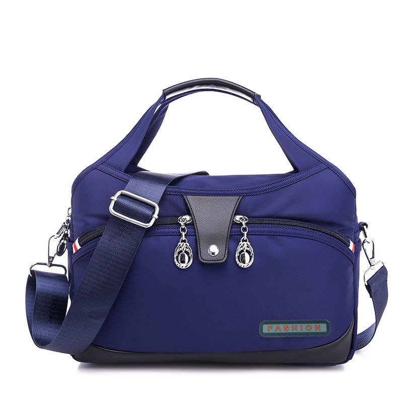 Blue handbag with a strap on a white background