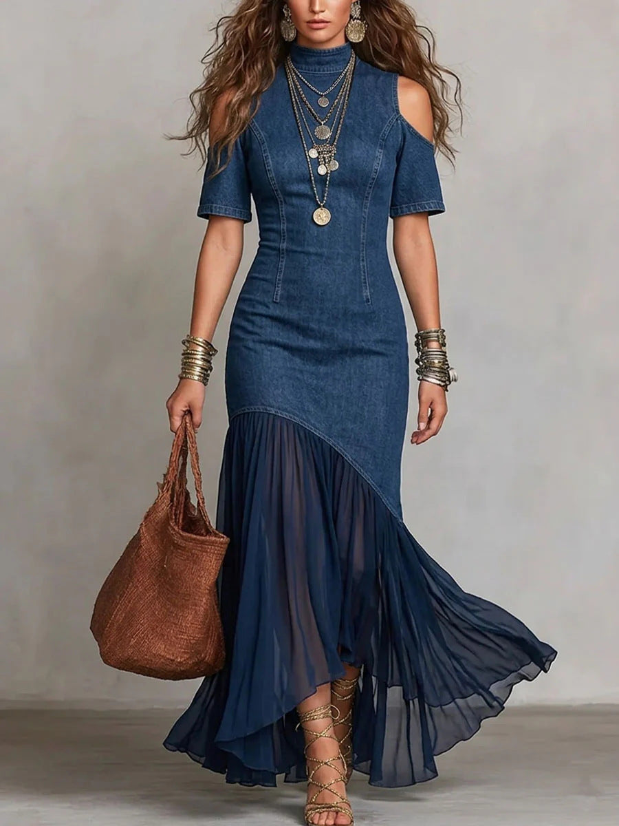 Woman wearing a blue dress with a brown handbag against a plain background by millivan