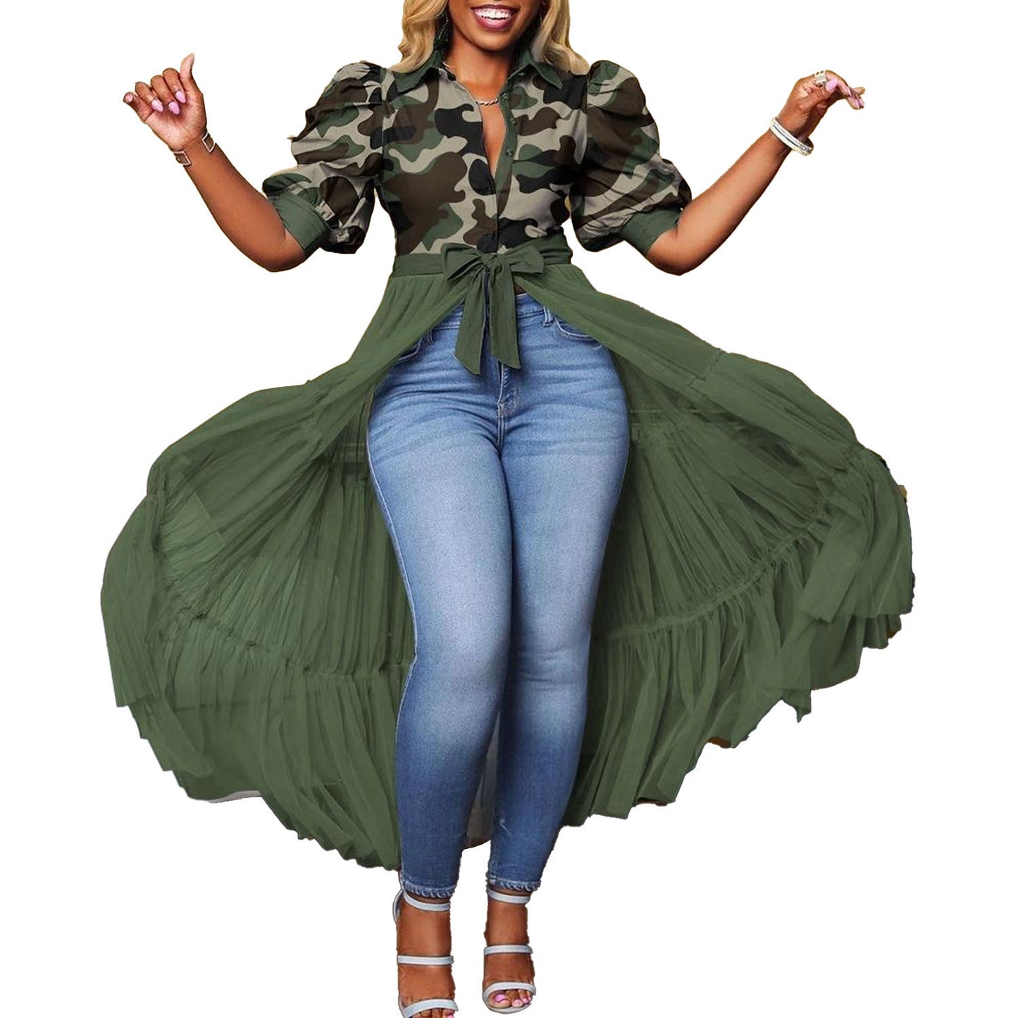 Woman wearing a camouflage top and green long coat with blue jeans on a white background