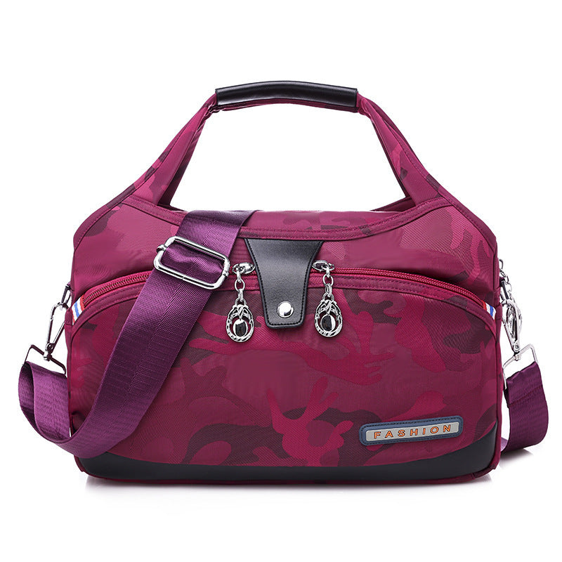 Purple camouflage handbag with a shoulder strap on a white background