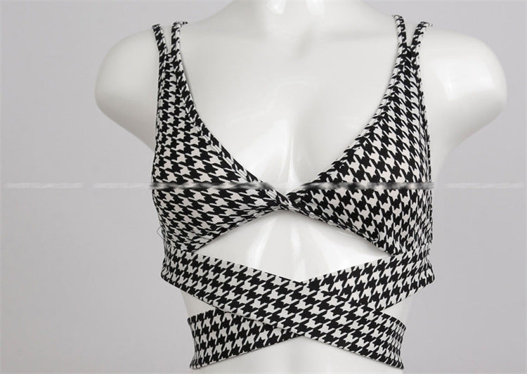 Black and white houndstooth patterned top on a mannequin against a white background