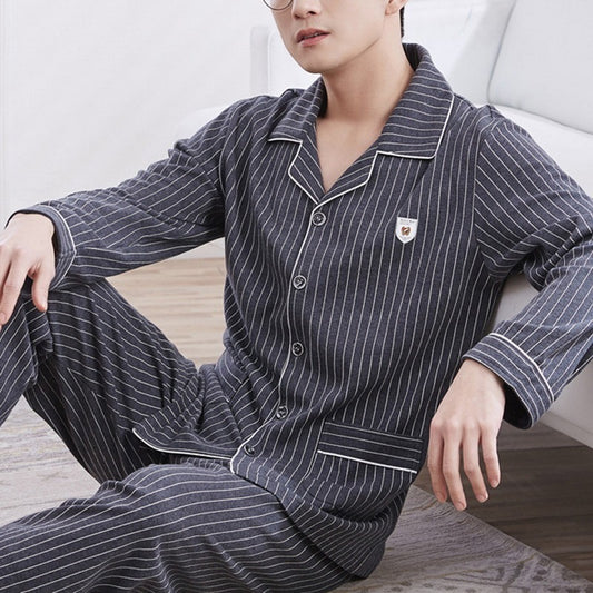 Person wearing a striped pajama set sitting on a couch.