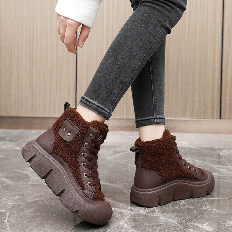 Brown winter boots with fleece lining worn by a person on a marble floor.