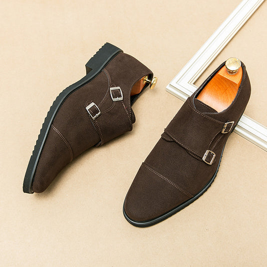 Brown suede shoes with buckles on a beige surface