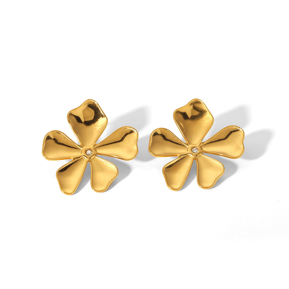 Gold flower-shaped earrings on a white background