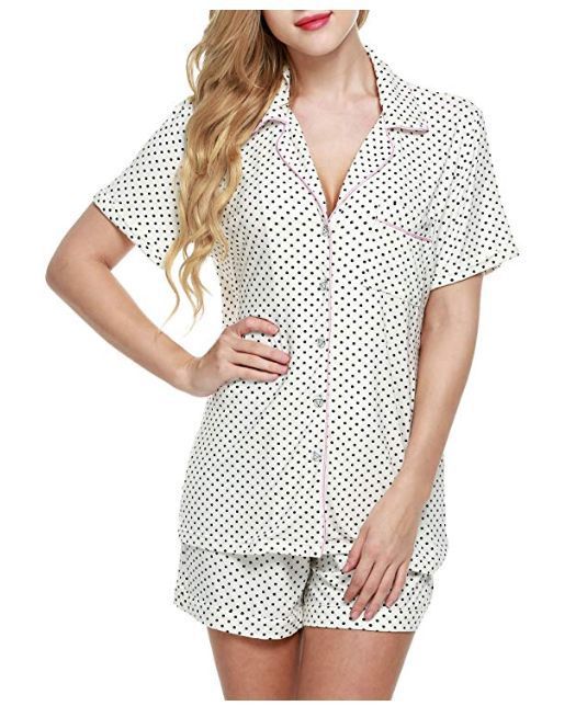 Woman wearing a polka dot pajama set on a white background