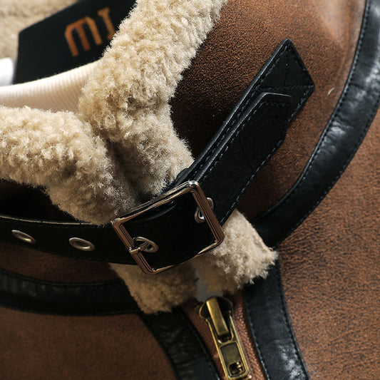 Close-up of a brown leather saddle with a black buckle and beige fleece lining.