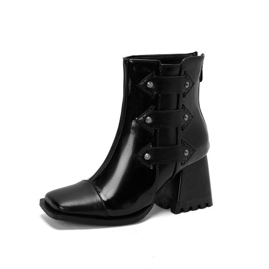 Black leather boot with buckle details on a white background