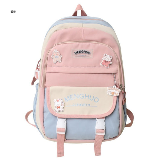 Pink and light blue backpack with cartoon character patches on a white background