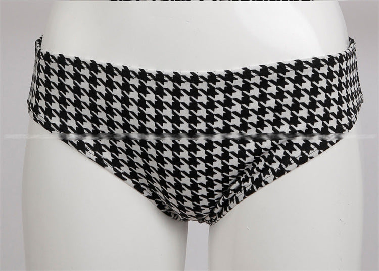 Black and white houndstooth patterned underwear on a mannequin against a white background