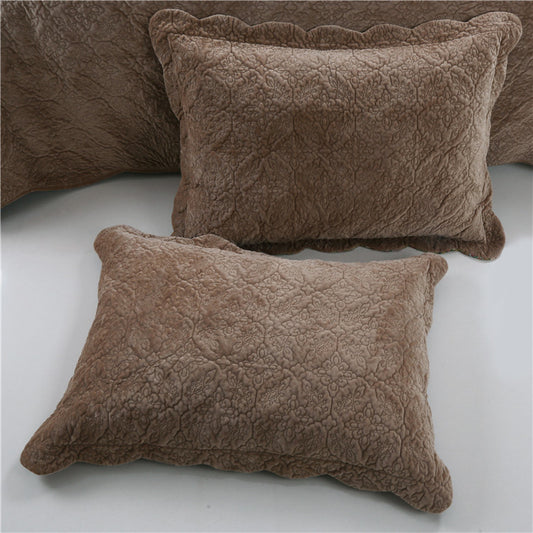 Two brown textured pillows on a light gray surface.