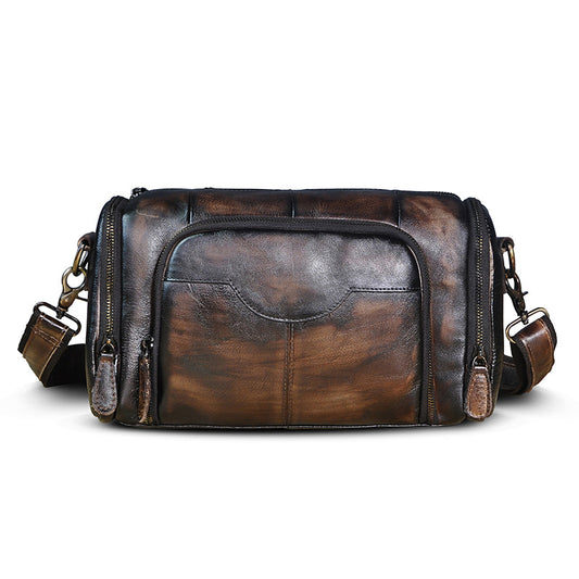 Brown leather bag with multiple zippers on a white background