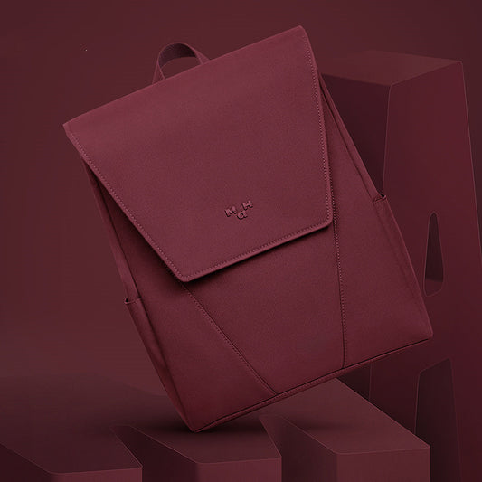 Maroon backpack on a matching background