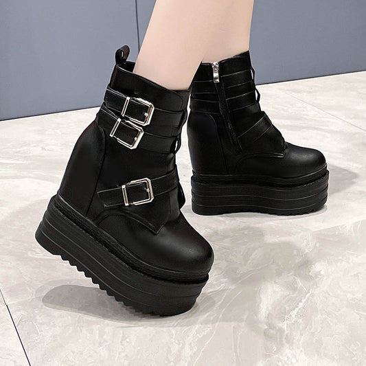 Black platform boots with buckles on a light gray background