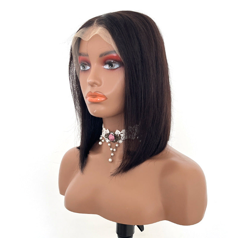 Black wig on a mannequin head with a white background