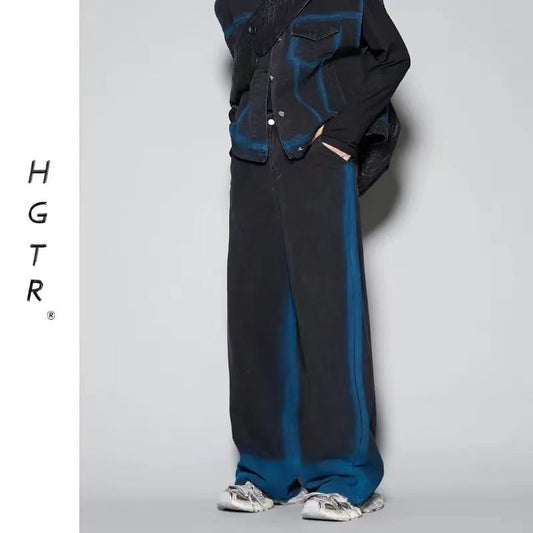 Person wearing a black and blue outfit with 'H G T R' branding on a light gray background
