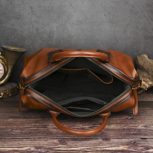 Brown leather bag on a wooden surface with a gray textured background