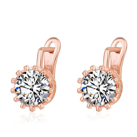 Rose gold earrings with clear gemstones on a white background