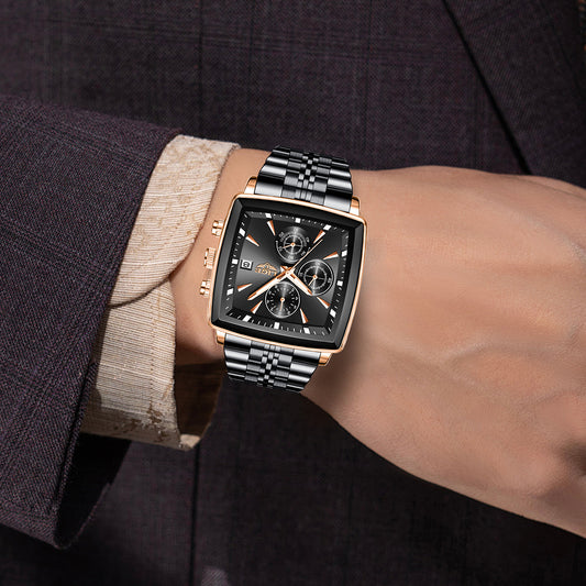 Luxury watch on a person's wrist with a dark suit background