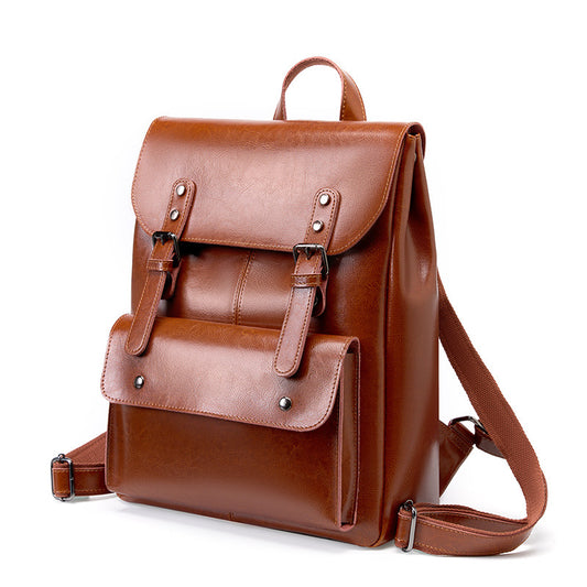 Brown leather backpack on a white background