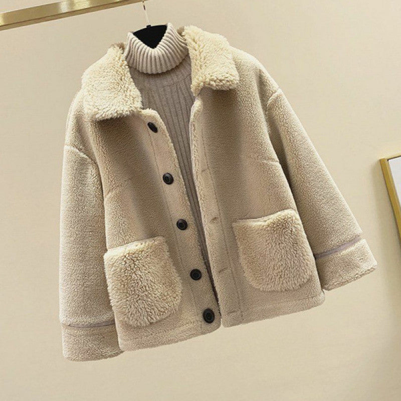 Beige sherpa jacket with black buttons on a beige background