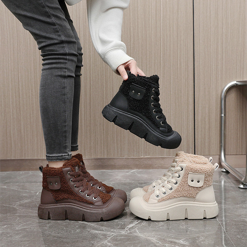 Three pairs of winter boots in black, brown, and beige on a reflective surface with a wooden floor background.