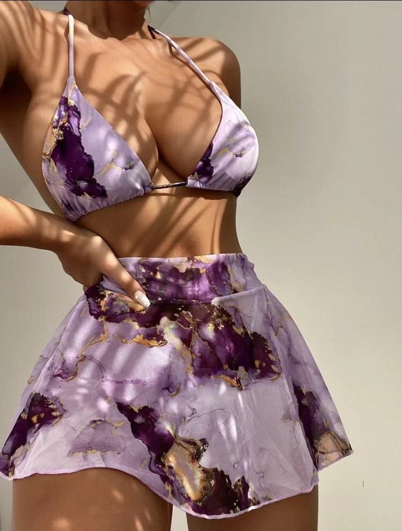 Purple floral bikini set on a neutral background