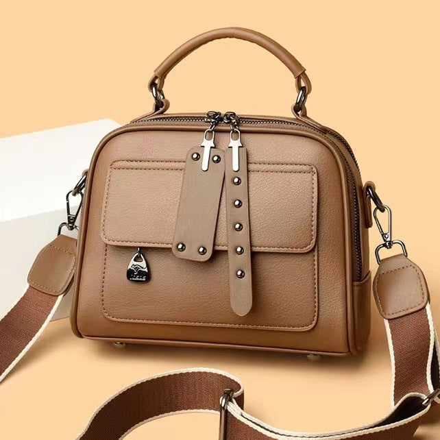 Brown handbag with a strap on a beige background