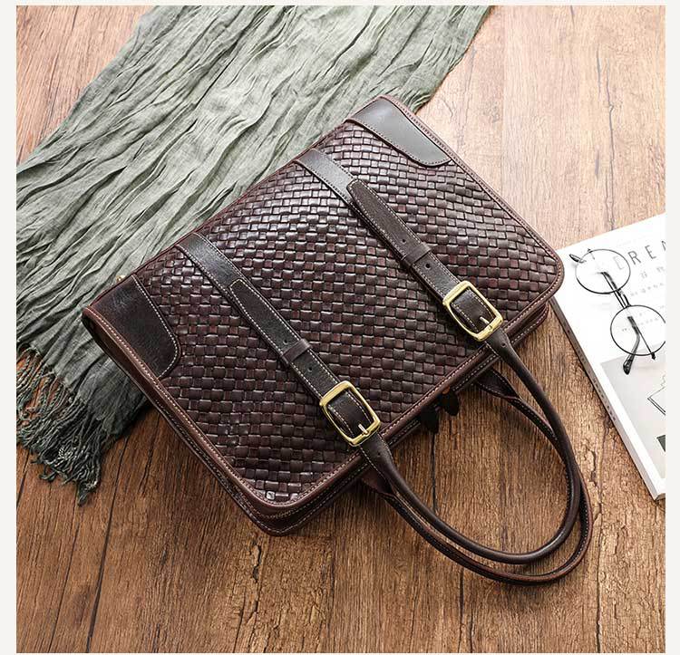 Brown woven handbag with a strap on a wooden surface