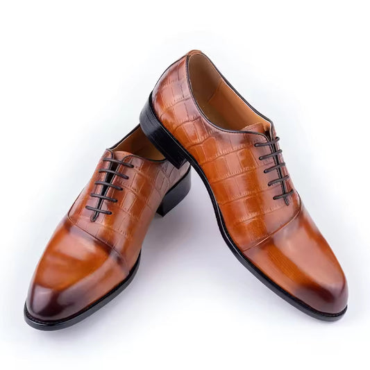 Pair of brown dress shoes with black soles on a white background