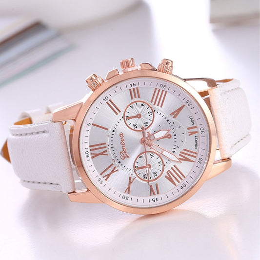 Rose gold watch with white strap on a light background