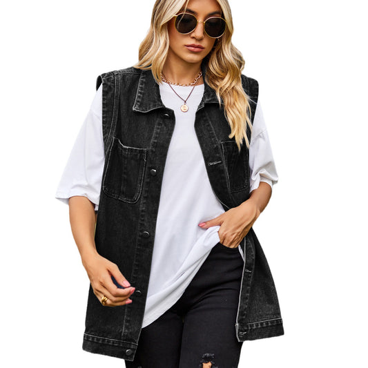 Woman wearing a black denim vest over a white shirt on a white background