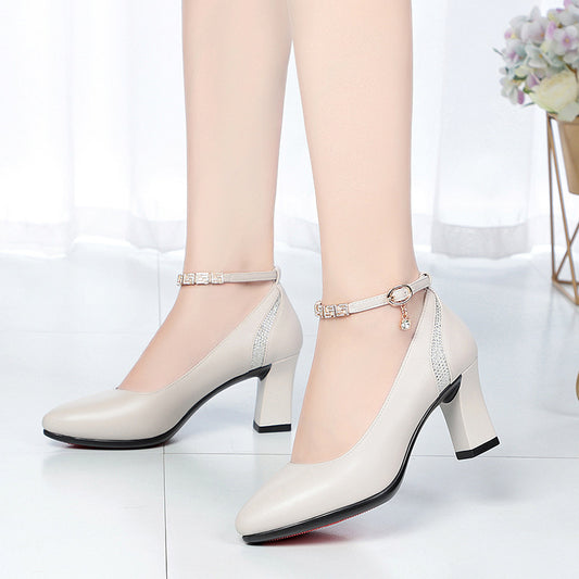White high-heeled shoes with ankle straps on a white background