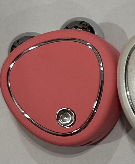 Pink door handle with silver trim on a light gray background