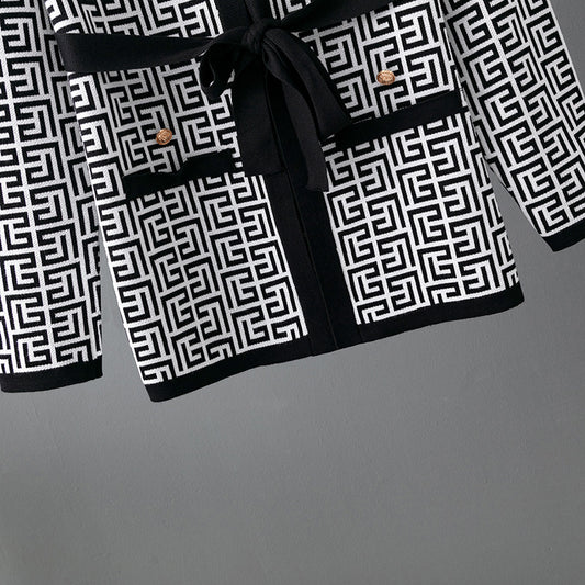 Black and white patterned robe with a belt on a gray background