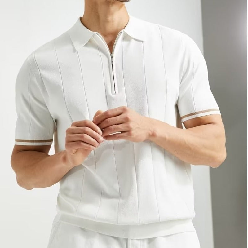 Man wearing a white short-sleeve shirt with a collar against a neutral background