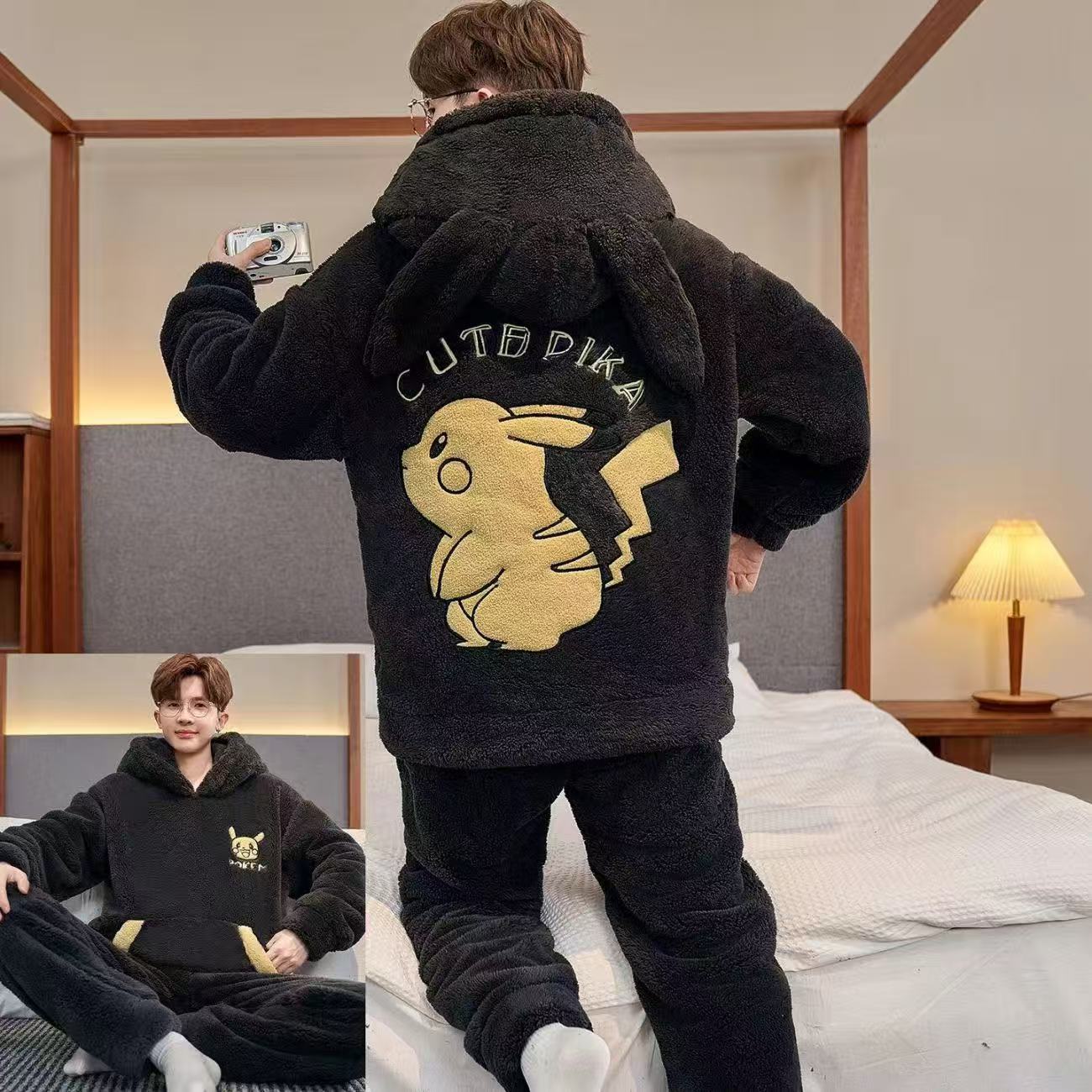 Person wearing a black hoodie with a cartoon character on the back in a bedroom setting.