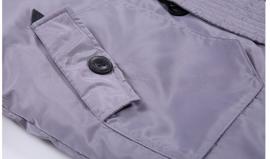 Close-up of a gray jacket with a button on a white background