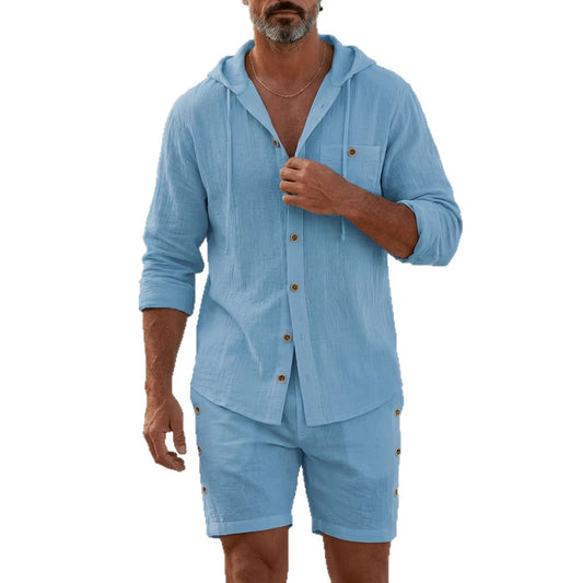 Man wearing a blue hooded shirt and shorts set on a white background