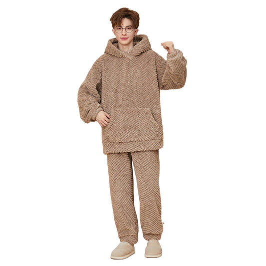 Person wearing a beige fleece hoodie and pants set on a white background